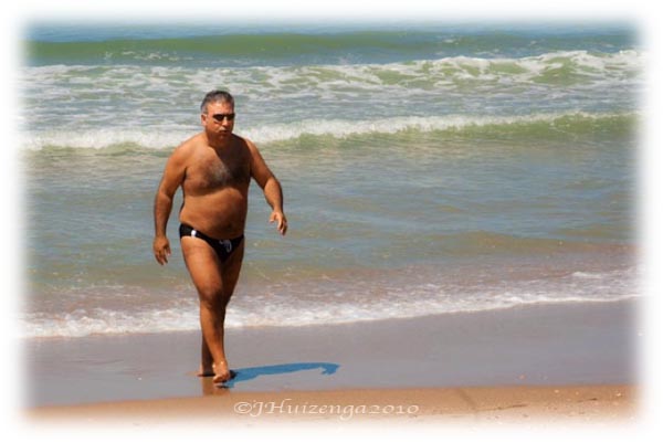 man in speedo on beach