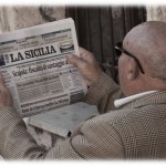 Sicilian man reading La Sicilia, copyright Jann Huizenga