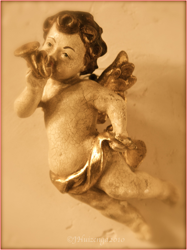 Winged Sicilian wooden cherub (putto) with horn, Copyright Jann Huizenga