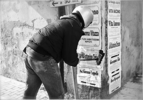Putting Up Death Notices in Sicily, Copyright Jann Huizenga