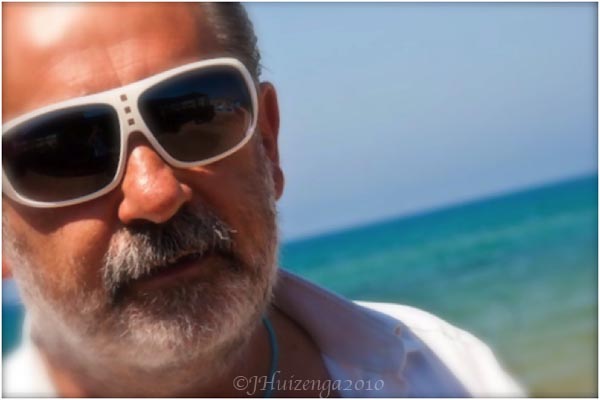 Sicilian Man in White Sunglasses at Beach, copyright Jann Huizenga