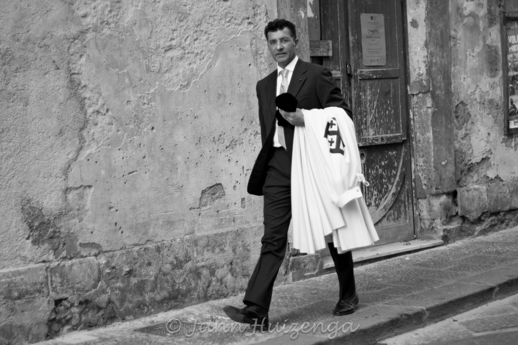 Sicilian Man Carrying Religious Robe, copyright Jann Huizenga