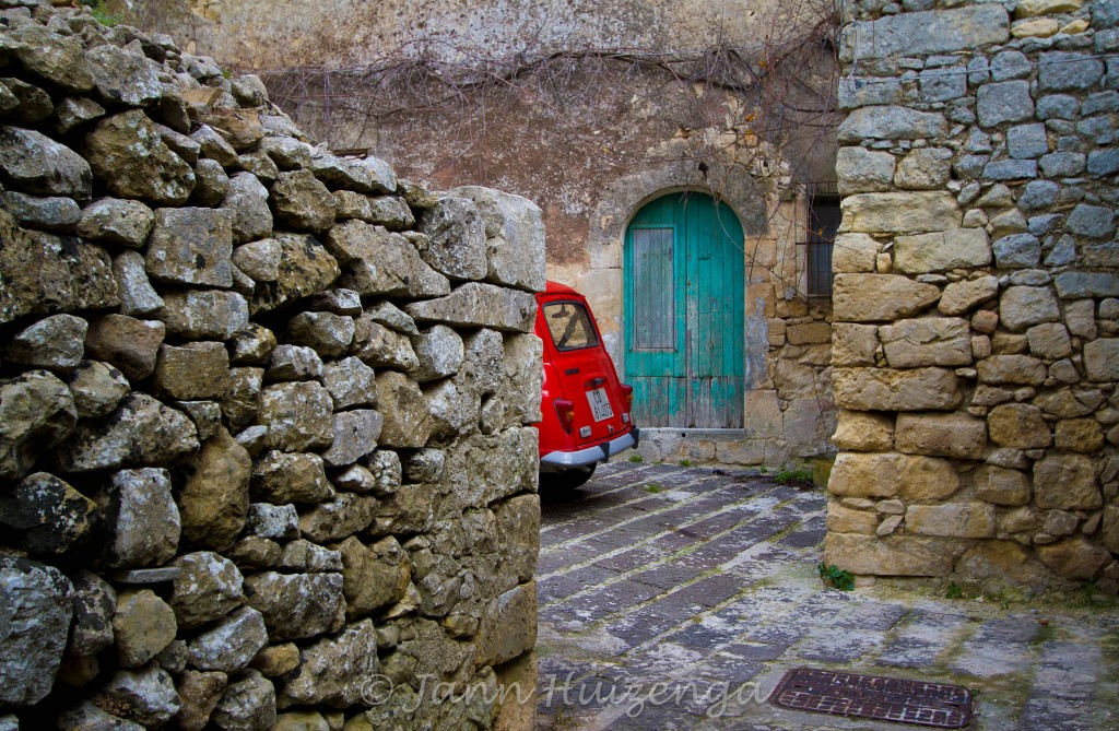 Red Car in Stone Courtyard in Sicily, copyright Jann Huizenga