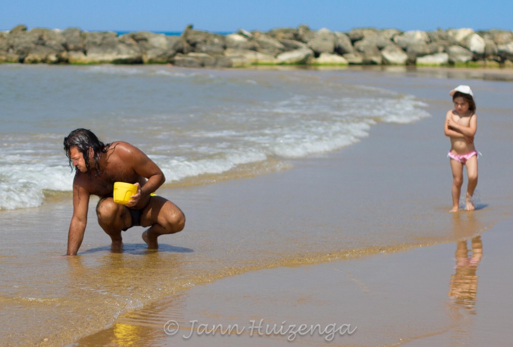 Sicilian Man Digging for Clams in Beach, copyright Jann  Huizenga