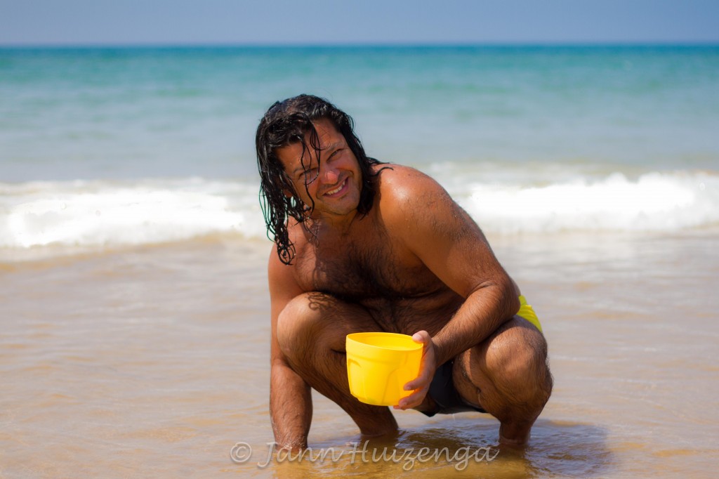 Sicilian Man Digging for Clams on the Beach, copyright Jann Huizenga