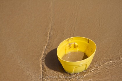 Yellow Bucket on Beach, copyright Jann Huizenga