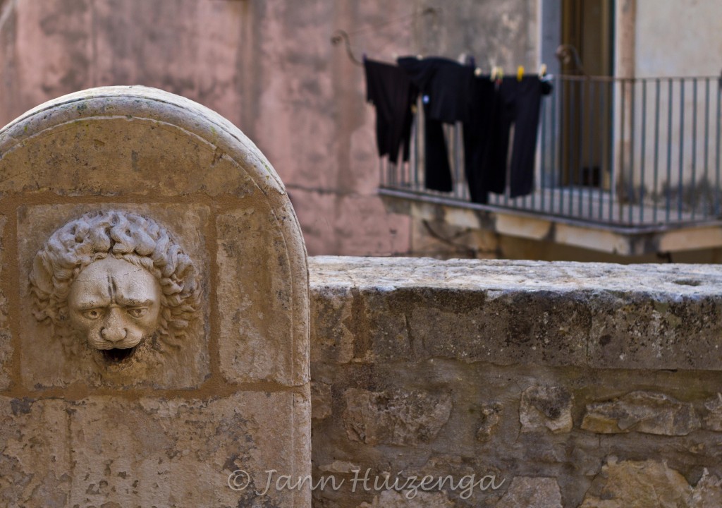 Stone lion fountain in Ragusa Ibla, copyright Jann Huizenga